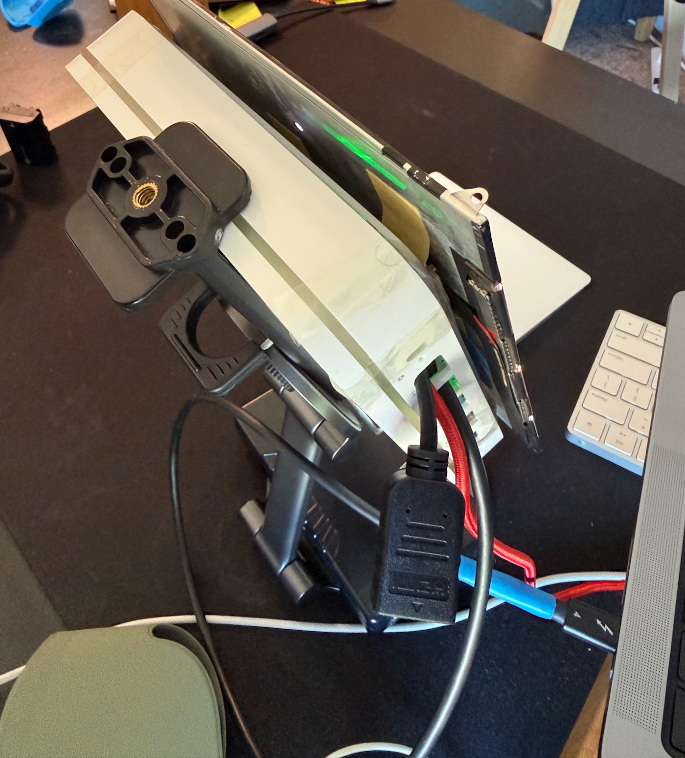 Side and back view. Can see the thunderbolt, USB, and HDMI cables comming out.